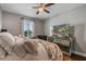 Serene bedroom with cozy bed, large TV, and plenty of natural light at 8300 Ludington Cir, Orlando, FL 32836