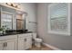 Elegant bathroom with a dark vanity and window shutters at 8300 Ludington Cir, Orlando, FL 32836