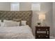 Main bedroom with tufted headboard and white bedding at 8300 Ludington Cir, Orlando, FL 32836