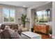 Modern living room with sectional sofa, large TV, and stylish decor at 8300 Ludington Cir, Orlando, FL 32836