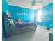 Bright bedroom with a full-size bed and blue walls at 181 Silver Maple Bnd, Davenport, FL 33837