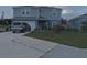 Two-story home with gray siding, attached garage, and landscaping at 181 Silver Maple Bnd, Davenport, FL 33837