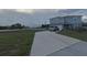 Two-story house with gray siding and a driveway; nice landscaping at 181 Silver Maple Bnd, Davenport, FL 33837