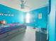 Blue-walled bedroom, full bed, window, and decor at 181 Silver Maple Bnd, Davenport, FL 33837