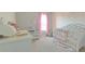 Bedroom with crib, changing table and neutral decor at 181 Silver Maple Bnd, Davenport, FL 33837