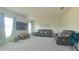 Open living room with plush seating and large windows at 181 Silver Maple Bnd, Davenport, FL 33837