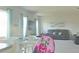 Spacious living room featuring a large TV and comfortable leather furniture at 181 Silver Maple Bnd, Davenport, FL 33837
