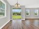 Dining room with hardwood floors, chandelier, and view of the backyard through sliding glass doors at 506 Ellie Ct, Apopka, FL 32703