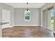 Bright dining room with hardwood floors, chandelier, and sliding glass doors leading to backyard at 506 Ellie Ct, Apopka, FL 32703
