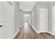 Long hallway with wood-look floors and neutral walls at 506 Ellie Ct, Apopka, FL 32703