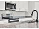 Granite countertop kitchen island with modern sink and faucet at 506 Ellie Ct, Apopka, FL 32703