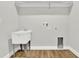 Laundry room with utility sink and built-in shelving at 506 Ellie Ct, Apopka, FL 32703