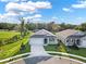 Aerial view of a modern house with a two-car garage and landscaping at 506 Ellie Ct, Apopka, FL 32703