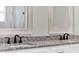 Double vanity bathroom with granite countertop and black matte faucets at 506 Ellie Ct, Apopka, FL 32703