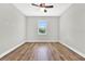 Well-lit bedroom featuring hardwood floors and a ceiling fan at 506 Ellie Ct, Apopka, FL 32703