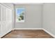 Bright bedroom with double doors and wood-look flooring at 506 Ellie Ct, Apopka, FL 32703