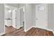 Bright entry hall with wood-look flooring, leading to bathroom and living spaces at 506 Ellie Ct, Apopka, FL 32703