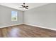 Bedroom with hardwood floors, ceiling fan, and large window with natural light at 506 Ellie Ct, Apopka, FL 32703