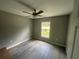 Simple bedroom with grey walls, vinyl flooring and ceiling fan at 142 Malauka Pass, Ocklawaha, FL 32179