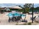 Community pool with lounge chairs and shaded seating areas at 435 Caribbean Dr, Davenport, FL 33897
