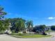 Landscaped entrance to the community with palm trees and a gated entryway at 435 Caribbean Dr, Davenport, FL 33897