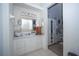 Well-lit bathroom with double sinks and a large mirror at 435 Caribbean Dr, Davenport, FL 33897