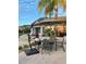 Relaxing patio area with outdoor furniture under a large umbrella at 435 Caribbean Dr, Davenport, FL 33897