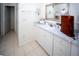 Clean bathroom with a vanity and a view of the hallway at 435 Caribbean Dr, Davenport, FL 33897