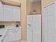 Kitchen boasts white cabinets, a large refrigerator, and additional counter space at 401 New Providence Promenade # 12401, Davenport, FL 33897