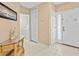 Bright entryway with tile flooring, storage closet, and glass-top accent table at 401 New Providence Promenade # 12401, Davenport, FL 33897