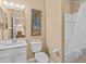 Clean bathroom with a toilet, sink, and bathtub at 401 New Providence Promenade # 12401, Davenport, FL 33897