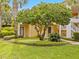Side view of a two-story yellow home with lush landscaping at 401 New Providence Promenade # 12401, Davenport, FL 33897