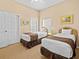 Bedroom with two twin beds, nightstands and window access at 401 New Providence Promenade # 12401, Davenport, FL 33897