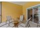 Covered patio with seating area and sliding glass door at 401 New Providence Promenade # 12401, Davenport, FL 33897