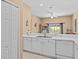 White kitchen features double sink, dishwasher, and ample cabinetry at 401 New Providence Promenade # 12401, Davenport, FL 33897