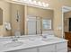 Double vanity bathroom with a large mirror and shower at 401 New Providence Promenade # 12401, Davenport, FL 33897