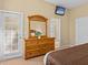 King-size bedroom with large dresser and private door access at 401 New Providence Promenade # 12401, Davenport, FL 33897