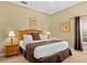 King-size bedroom with nightstands and window access at 401 New Providence Promenade # 12401, Davenport, FL 33897