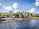 Relaxing lakefront view with beach access and lounge chairs at 401 New Providence Promenade # 12401, Davenport, FL 33897