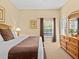 King-size bedroom with dresser, window access, and neutral decor at 401 New Providence Promenade # 12401, Davenport, FL 33897