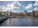 Lakefront community with a boardwalk and lounge chairs at 401 New Providence Promenade # 12401, Davenport, FL 33897