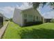 Tan house exterior with a manicured lawn and hedgerow at 333 Silver Maple Rd, Groveland, FL 34736