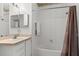 Bright bathroom featuring a tub, shower, and updated vanity at 8810 Dunes Ct # 203, Kissimmee, FL 34747