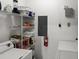 Convenient laundry room with washer, dryer, shelving, and extra storage space at 8810 Dunes Ct # 203, Kissimmee, FL 34747