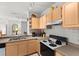 Nice kitchen featuring light wood cabinets, modern appliances, and a breakfast bar at 8810 Dunes Ct # 203, Kissimmee, FL 34747