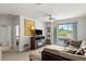 Spacious living room with neutral carpeting, sliding glass doors to balcony, and comfortable seating at 8810 Dunes Ct # 203, Kissimmee, FL 34747