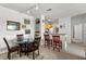 Dining area with glass-top table and four chairs, adjacent to kitchen at 8810 Dunes Ct # 203, Kissimmee, FL 34747