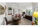 Living room with glass dining table, dark brown chairs, and a black couch at 8810 Dunes Ct # 203, Kissimmee, FL 34747