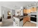 Open kitchen design with a breakfast bar, stainless steel sink, and modern appliances at 8810 Dunes Ct # 203, Kissimmee, FL 34747
