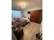 Bright bedroom with wood-look floors, large closet, and comfortable bed at 4301 Lizshire Ln # C-109, Orlando, FL 32822